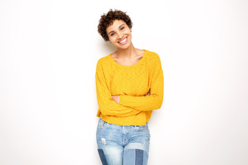 happy smiling young woman with arms crossed against isolated white background