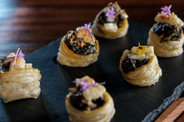 Escargots- Snails with herbs and spices on puff pastry. Gourmet delicacy appetizer