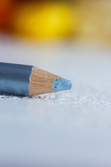 cosmetic pencil for applying makeup on the face close-up. eye liner in macro on blurred background