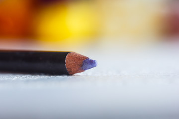 cosmetic pencil for applying makeup on the face close-up. eye liner in macro on blurred background