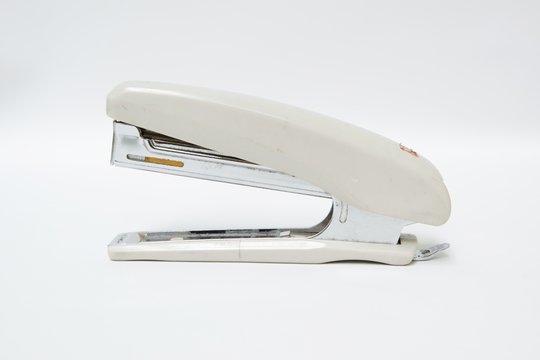 Stapler isolated on white background. Top view close up details.