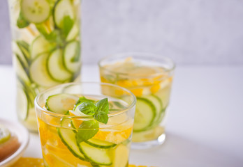 Fototapeta na wymiar Refreshing summer drink with lemon, ginger, fresh cucumber and mint.