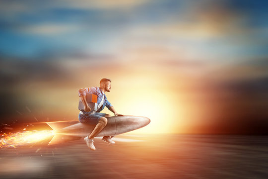 A man flies on a rocket, delivers parcels. Super fast delivery, cool service, online purchase. Copy space, Mixed media