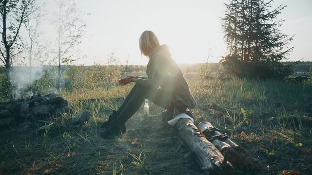 Girl Sitting in Front of Fire. Slow motion footage.