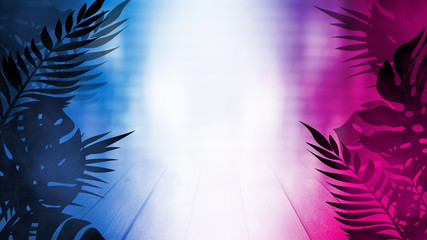 Wooden table on the background of bright neon figures, light. Silhouettes of tropical palm leaves in the foreground. Bright futuristic abstract background