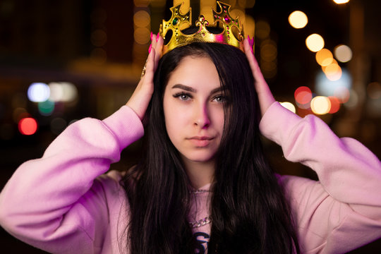 Rich girl wear gold crown at night city like a queen