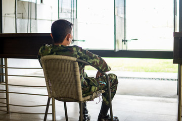 soldier, man sitting on a bench in the gunfield