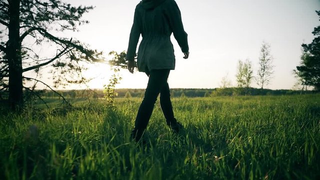 Young Woman Walking on Mountain Trail. Slow motion steadicam footage. Amazing sunset. Nature landscape.