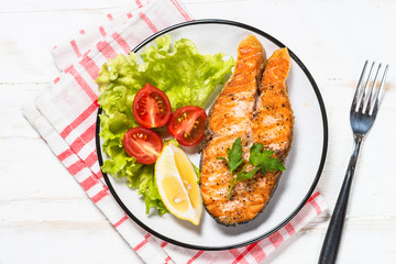Grilled salmon fish steak on white.