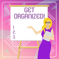 Text sign showing Get Organized. Business photo showcasing arranged according to a particular system Coherent unity White Female in Glasses Standing by Blank Whiteboard on Stand Presentation