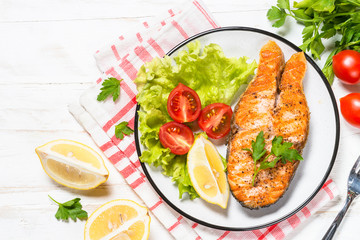 Grilled salmon fish steak on white.