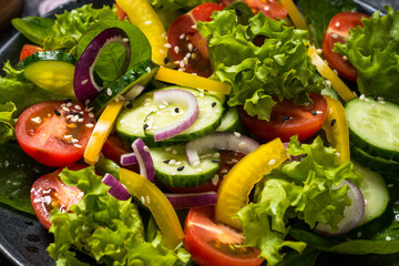 Fresh vegetables salad on black.