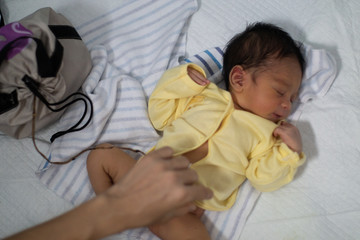 A portrait of a 42-day-old boy born in a lotus birth. Unlike babies in general, the baby's...