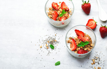 Tasty Strawberry Dessert, Homemade Yogurt with Strawberries, Granola and Chia Seeds over Bright Background