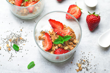 Tasty Strawberry Dessert, Homemade Yogurt with Strawberries, Granola and Chia Seeds over Bright Background
