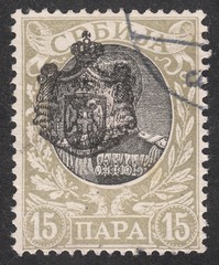 Obraz premium Portrait of king Alexander I Obrenovich,overprint state emblem, stamp Serbia circa 1903