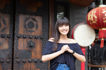 Fototapeta na wymiar Portrait of smiling young asian woman enjoy in China town