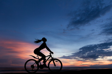 Fototapeta premium Silhouette photo of woman riding on bicycle