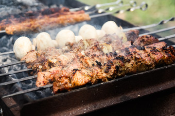 grilled meat and mushrooms on the grill. barbecue close up