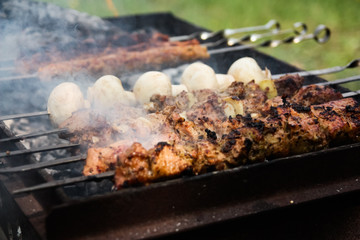 grilled meat and mushrooms on the grill. barbecue close up