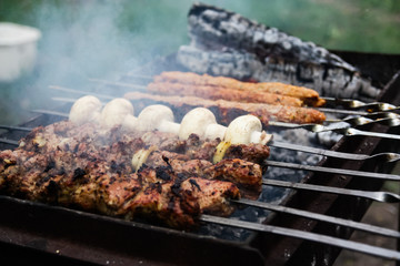 grilled meat and mushrooms on the grill. barbecue close up