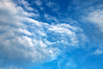 Beautiful white clouds, cumulonimbus, cumulus, rain clouds against a blue sky. Picturesque, fantastic white clouds, landscape background for summer, spring poster.