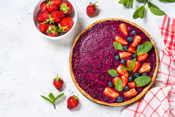 Berry cheesecake on white table top view.