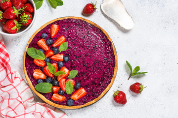 Berry cheesecake on white table top view.
