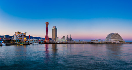 Naklejka premium Port of Kobe city skyline before sunset in Kansai, Japan - Panorama