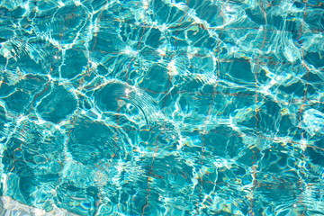 A background of crystal clear water with the sunshine reflecting off the ripples