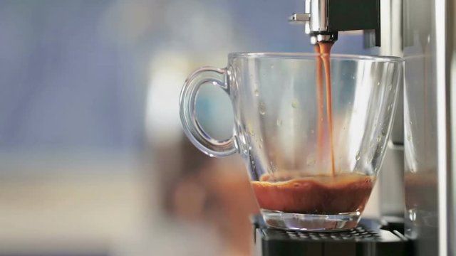 Preparation of natural delicious coffee in the automatic coffee machine. A charge of vivacity every day. Good morning