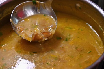 Taking soup into a plate. Delicious homemade mushroom soup served in a plate.