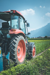 Cut out of tractor cultivating field in spring, agriculture