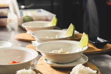 Professional chef cooking in the kitchen restaurant at the hotel, preparing dinner. A cook in an apron makes a salad of vegetables and pizza.