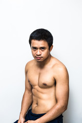 Fototapeta premium Smart and strong asian muscle man posting on white background