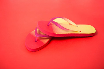 Beach flip flop on red background