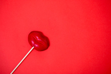 Red lollipop on coral background