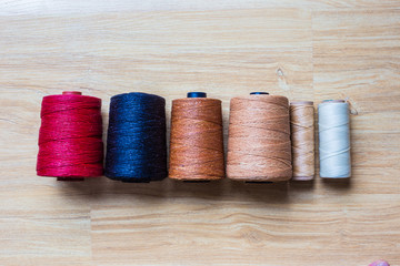 Wax color thread leather crafts woorking on wood background