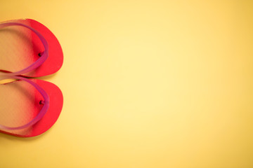 Beach flip flop on yellow background