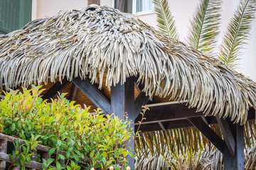 Large gazebo with roof made of palm branches.