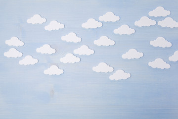 white clouds on a blue wooden background