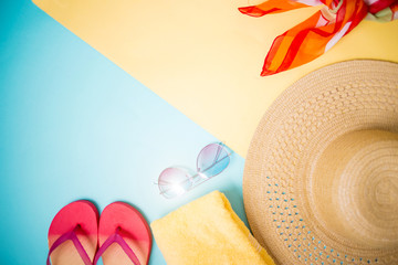 Beach accessories on yellow blue background