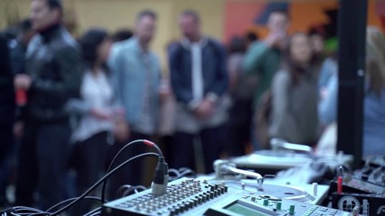Nightlife in Barcelona. People walking on the background. Dark silhouettes and lights. Girl watching telephone. Crowd in a venue, party, exhibition. Creative background. 