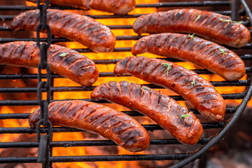 Fototapeta premium Top view of sausage on grill with spices in summer