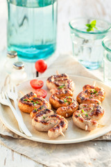 Grilled and twisted sausage with herbs and spices in summer