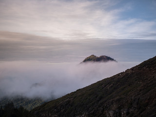 Mountain top seen through clouds