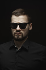 Fototapeta premium Portrait of Man in Black Indoors