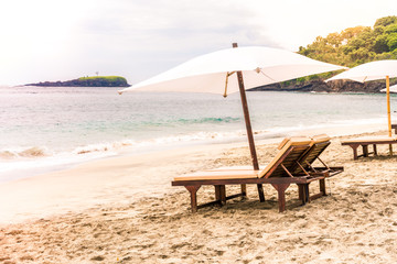 Empty sunbeds waiting for tourists on Virgin beach or Pasir Putih or Perasi Beach on Bali, Indonesia. Beautiful and clean tropical white sand beach