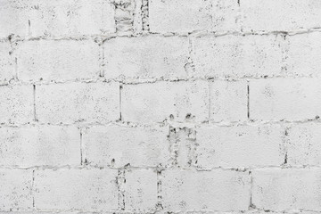 Fototapeta premium closeup of white decay brick wall abstract background wallpaper or web banner with copy space.