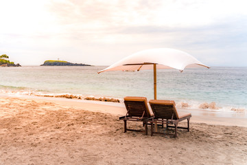 Empty sunbeds waiting for tourists on Virgin beach or Pasir Putih or Perasi Beach on Bali,...